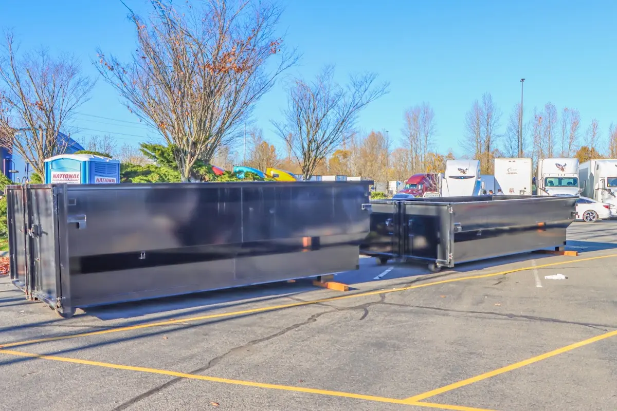 Professional dumpster rental service with roll-off container on residential driveway in Mira Monte